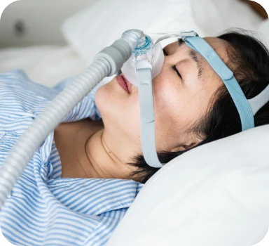 Woman sleeping with a CPAP mask for sleep apnea treatment
